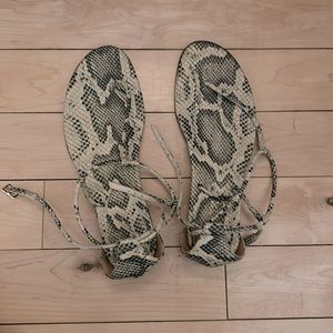 Paris Texas faux snakeskin thong sandals with wraparound ankle strap.